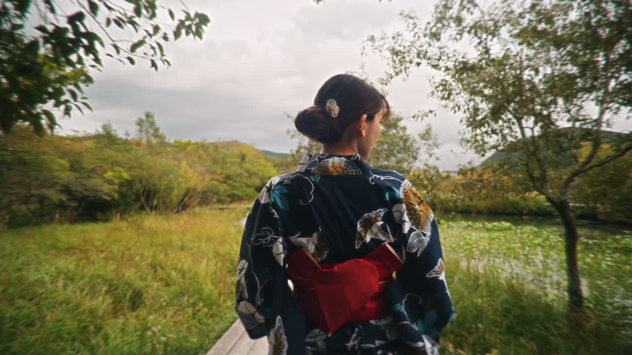 Woman in Kimono Walking on Boardwalk in Nature