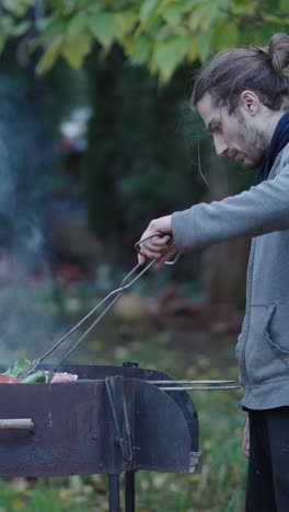 man grilling food outdoors
