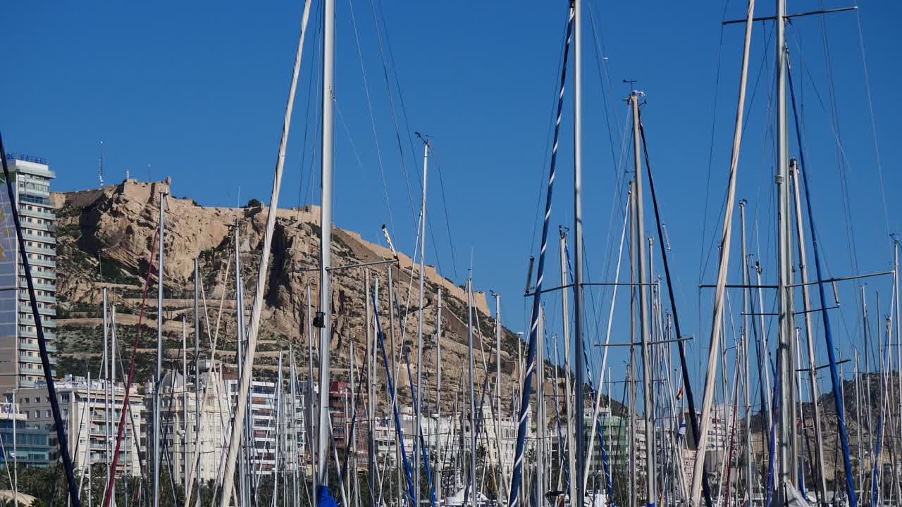 Sailing ship masts with Santa Barbara Castle in the background, Alicante, Spain