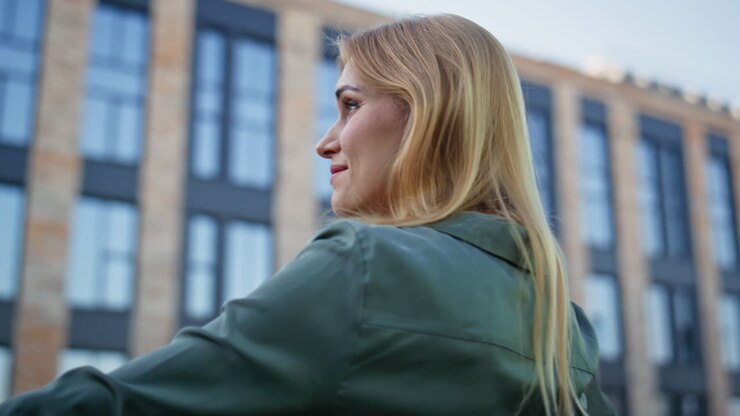 Closeup blonde lady looking views downtown. Creative smiling manager pondering