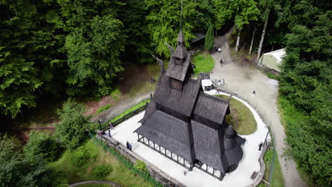 Aerial-view-around-the-famous-Fantoft-Stave-church,-sunny-summer-day-in-Norway