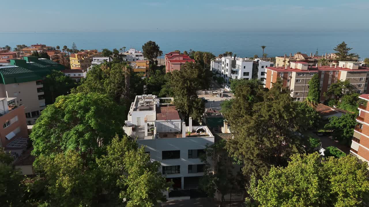 Smooth transition from top-down to aerial view of peaceful apartment neighborhood by water