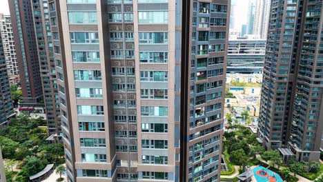aerial shot showcasing modern residential towers in shenzhen, surrounded by lush green spaces and urban infrastructure. captures urban living in china.