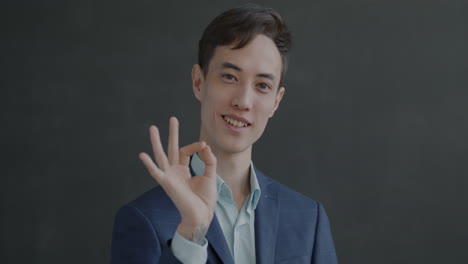 smiling asian man in a suit