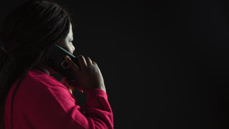 black woman talking on digital phone