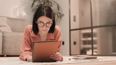 woman using tablet computer on floor