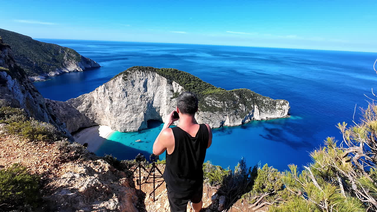 Man admiring Navagio Beach, Elatia, Greece, tranquil sea view