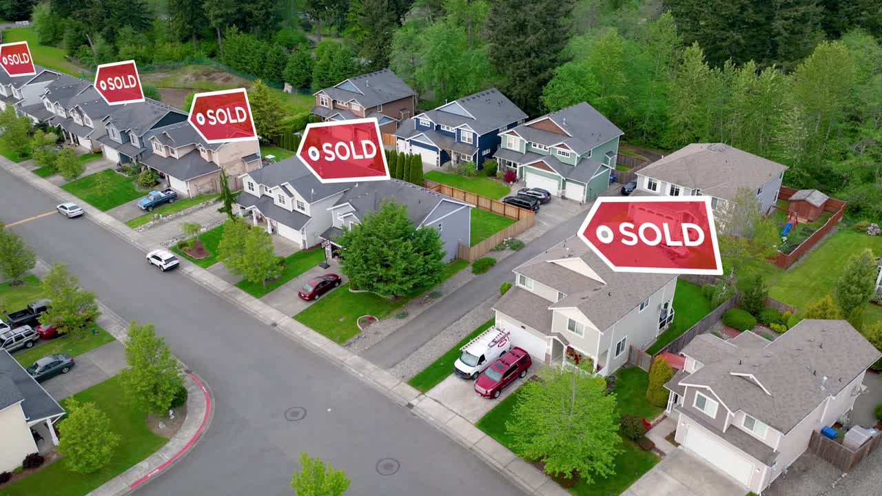 Aerial view of a suburban neighborhood with "SOLD" signs animating above the houses