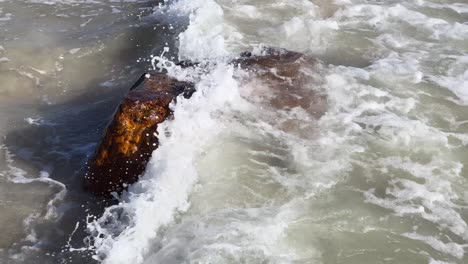 waves-breaking-over-rock-on-beach