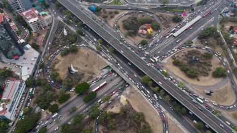 overhead drone perspective of highways, avenues, and a cloverleaf interchange in southern cdmx