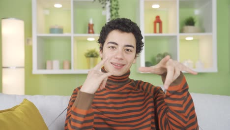 fun and cheerful boy monkeying on camera at home, chatting, having fun