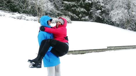 Man-carrying-woman-in-his-arms-in-forest