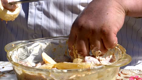 fat man puts the pickled meat on a skewer for a shish kebab