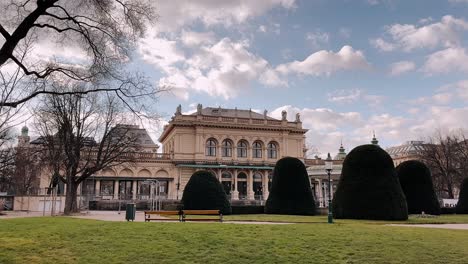 elegant historic building in vienna's park with manicured greenery and blue skies