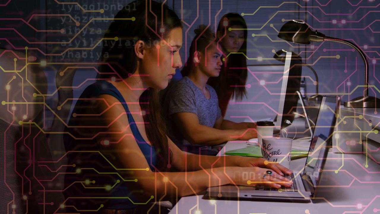 Team of Programmers Working on Laptops with Digital Circuit Board Overlay