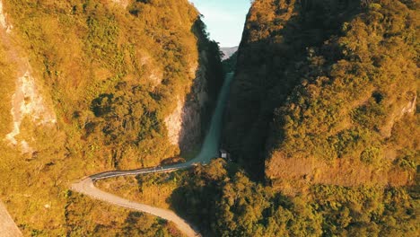 amazing road inside a tropical rainforest mountain crack at sunrise aerial view, serra do corvo branco, grão pará, santa catarina, brazil