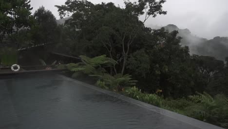 panning shot from a villa in the rwandan countryside with the rain pouring down