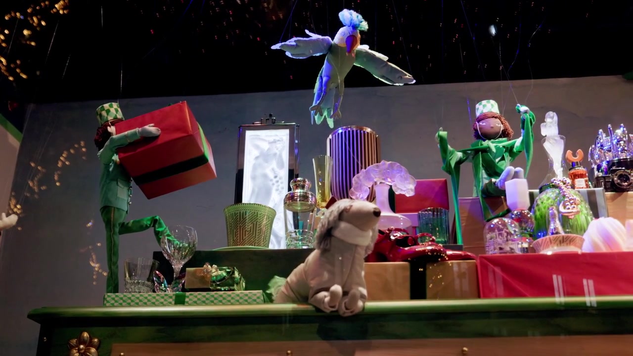 Festive window display featuring colorful puppets and Christmas decor in a Paris boutique