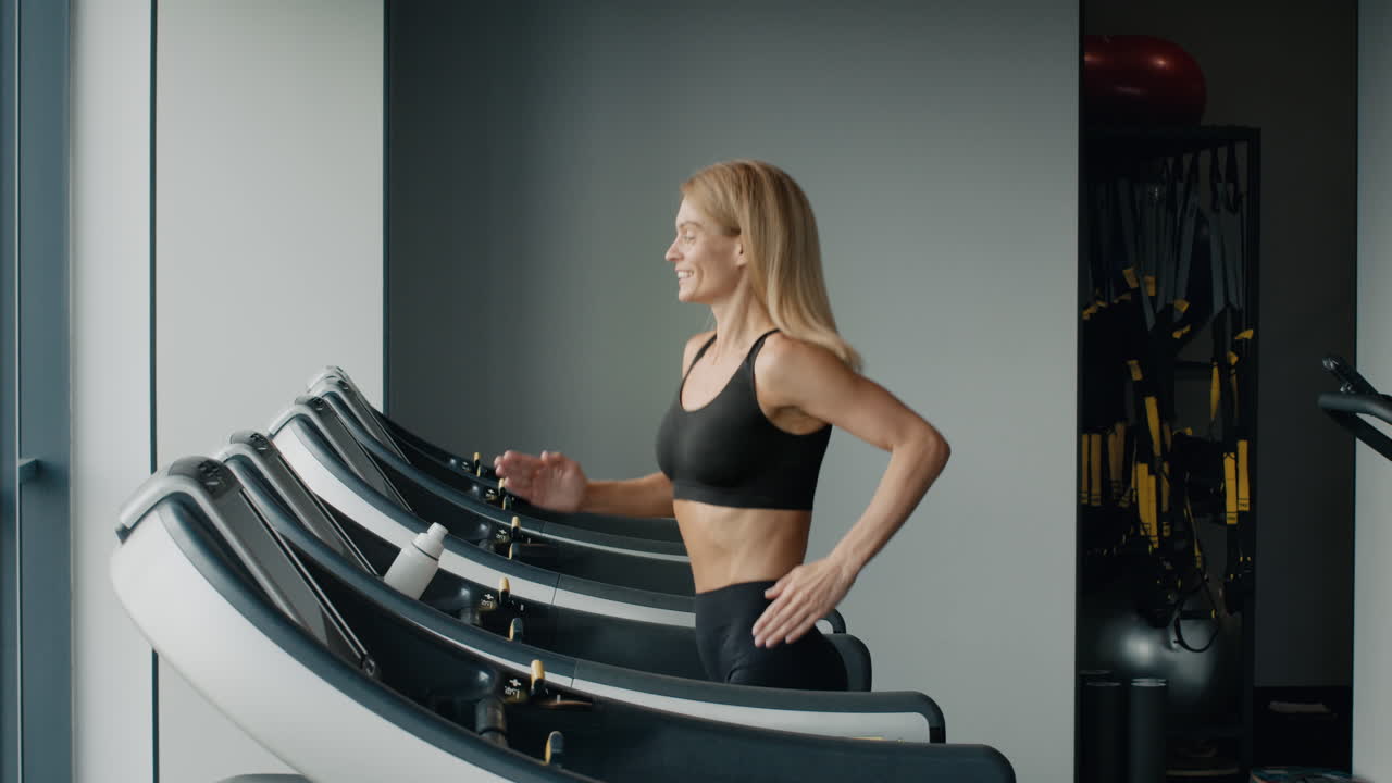 Woman Running on Treadmill in Gym