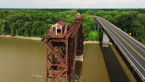 main highway near rusty truss bridge over white river in twin city riverfront park, arkansas, usa