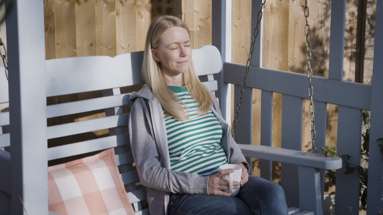 Woman relaxing on a swing outdoors
