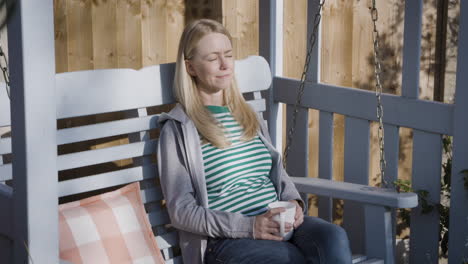 woman relaxing on a swing outdoors