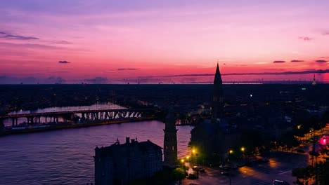 city lights illuminating as the sun sets, creating a stunning transition from day to night over the urban skyline