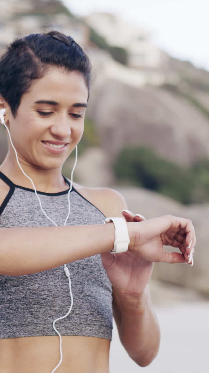 Young Woman Smiling While Checking Smartwatch Outdoors