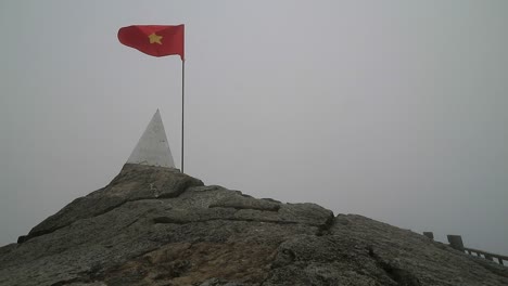 hd vietnam flag on top of fansipan mountain in sapa, vietnam