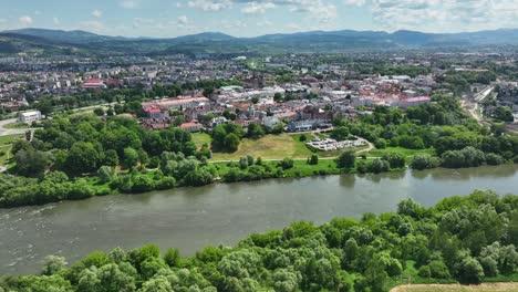 contemporary city residential area and old town by river aerial, lesser poland