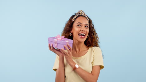 excited, woman shake gift and box in studio