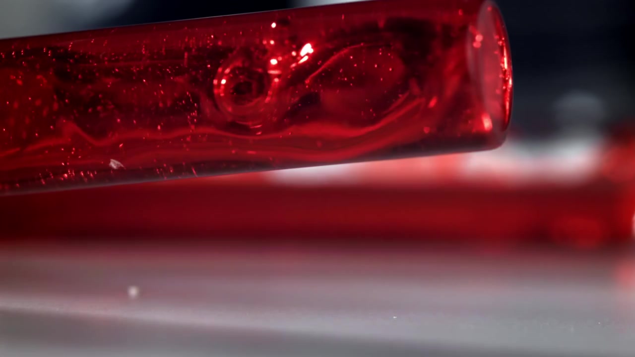 Close-up of Red Fluid Swirling in a Laboratory Test Tube