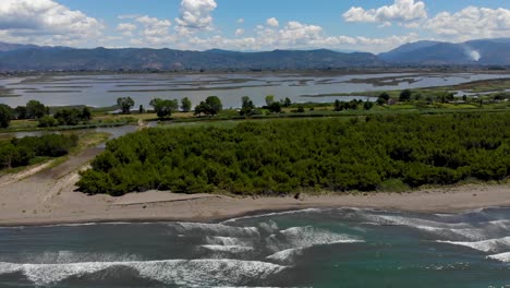 Sea-waves-foaming-on-Mediterranean-seaside-with-sandy-beaches-and-natural-lagoon-of-Kune,-Albania