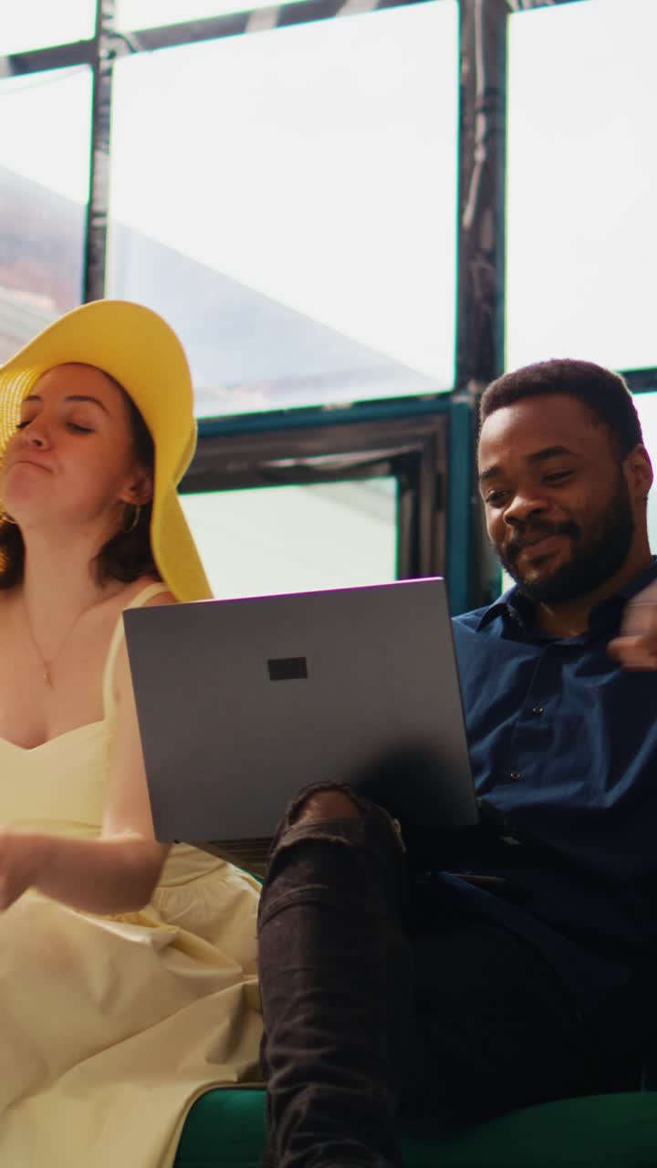 Vertical video Hotel guests creating itinerary on pc