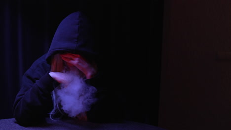 anonymous-hooded-person-smoking-cigarette-then-collapsing-in-a-dark-room