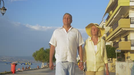 couple walking along the promenade holding hands