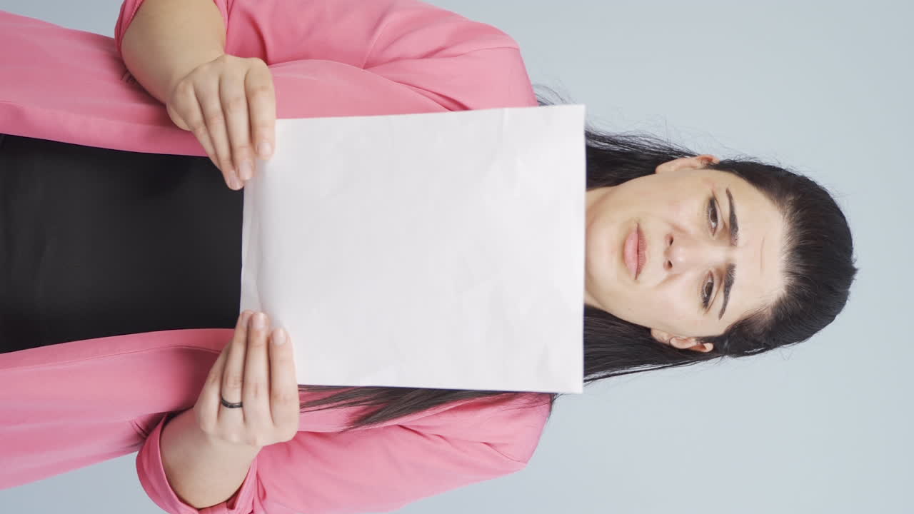 Vertical video of Business woman examines paperwork and gets upset.