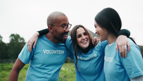group of volunteers embracing in a field