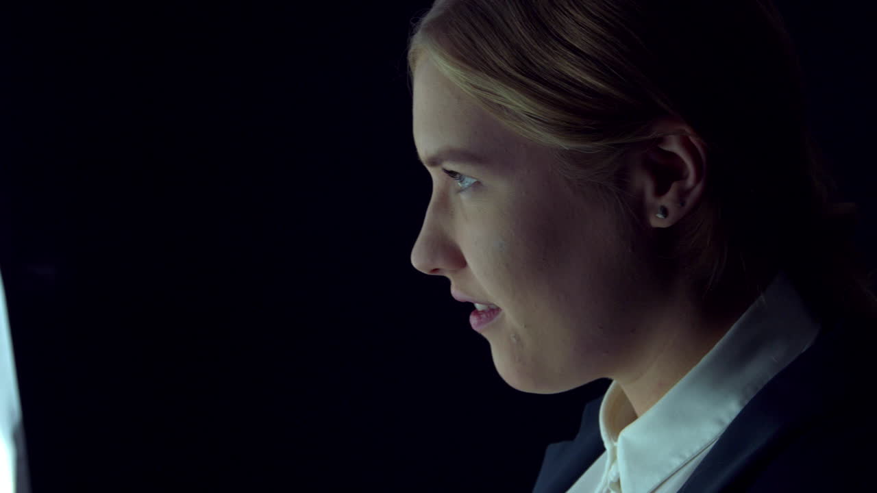 Slow motion of a blond business woman approaching a virtual screen,