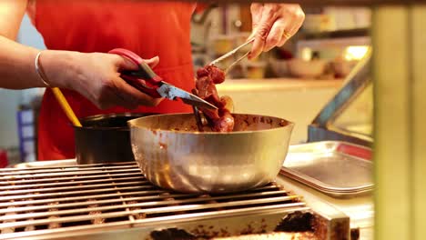 chef preparing skewers at a food stall