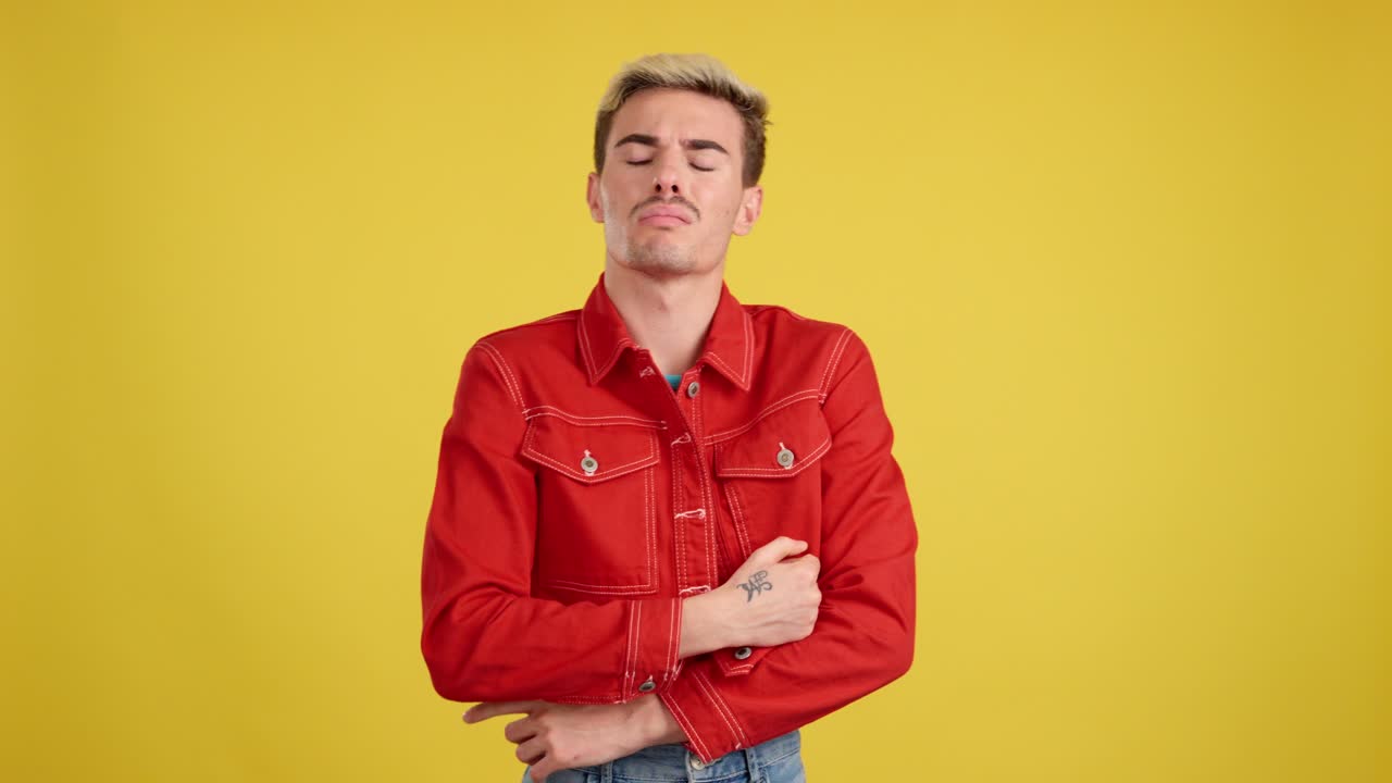 Man in Red Jacket Posing Against Yellow Background