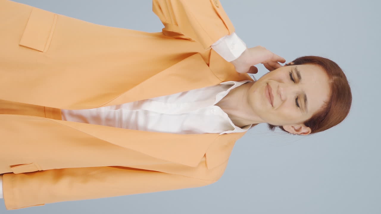 Vertical video of Business woman scratching her ear.