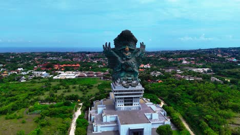 majestic statue of bali island, high angle aerial orbit view
