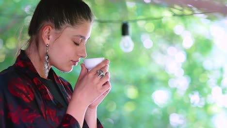 young woman enjoying tea outdoors