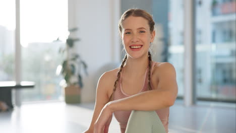 smiling woman with braids practicing yoga indoors