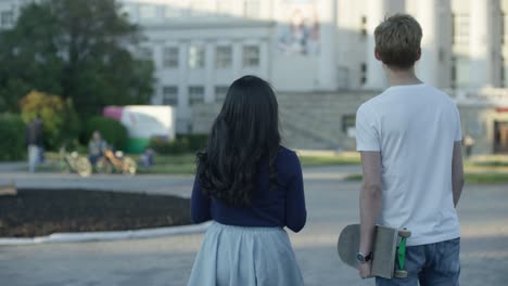 couple walking in a city park