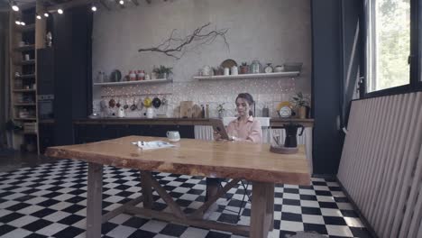 woman working on tablet in a modern kitchen