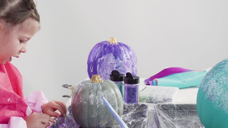 Decorating art pumpkins in mermaid theme for Halloween