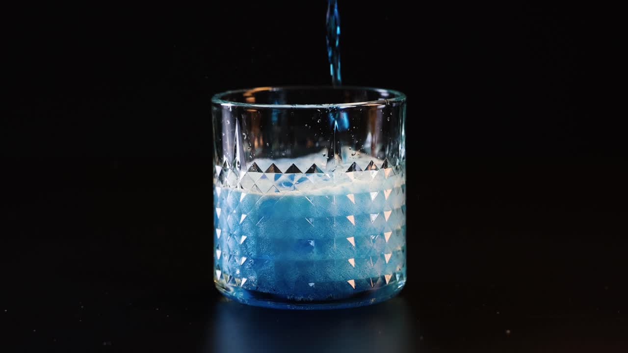 파란 액체가 유리통에 부어서 거림을 일으킨다.