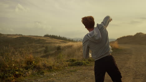 sportsman jumping on trail outdoor. guy enjoying good results after training